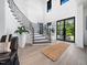 Bright entryway featuring a winding staircase with wood treads and modern railing near large windows at 604 Dappled Pine Ave, Durham, NC 27713