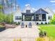 Charming backyard exterior featuring a patio with seating and lush landscaping at 604 Dappled Pine Ave, Durham, NC 27713