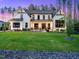 Beautiful home with a manicured lawn, trimmed bushes and a stone border at 604 Dappled Pine Ave, Durham, NC 27713