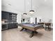 Game room features a pool table, sleek bar area, hardwood floors, and recessed lighting at 604 Dappled Pine Ave, Durham, NC 27713