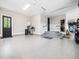 Spacious garage with epoxy flooring, storage racks and access to the house at 604 Dappled Pine Ave, Durham, NC 27713