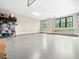 Bright and clean garage featuring epoxy flooring and two windows, offering ample natural light at 604 Dappled Pine Ave, Durham, NC 27713
