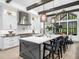 Open kitchen features white cabinetry, stainless appliances, quartz countertops, and large island at 604 Dappled Pine Ave, Durham, NC 27713
