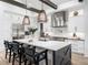 Bright, modern kitchen with large island, stainless steel appliances, and stylish pendant lighting at 604 Dappled Pine Ave, Durham, NC 27713