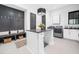 Modern laundry room featuring a central island, sleek cabinetry, and high-end washer and dryer units at 604 Dappled Pine Ave, Durham, NC 27713