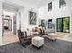 Bright living area with seating, a staircase, and modern decor, perfect for relaxation and entertaining at 604 Dappled Pine Ave, Durham, NC 27713
