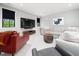 Comfortable living room with modern furniture, neutral tones, and ample natural light at 604 Dappled Pine Ave, Durham, NC 27713