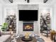 Comfortable and modern living room features a decorative fireplace, open shelving, and decor at 604 Dappled Pine Ave, Durham, NC 27713