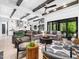 Large living room with beamed ceilings, ceiling fan, and modern furnishings overlooking backyard at 604 Dappled Pine Ave, Durham, NC 27713