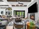 Bright living room showcases fireplace, tv, beamed ceilings, and access to outside views at 604 Dappled Pine Ave, Durham, NC 27713