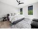Bright main bedroom with a neutral color scheme, hardwood floors, and two large windows at 604 Dappled Pine Ave, Durham, NC 27713