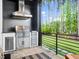 Outdoor kitchen featuring a built-in grill and countertop space, with a view of the yard at 604 Dappled Pine Ave, Durham, NC 27713