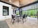 Covered patio with a fireplace, TV, dining set and views to the kitchen at 604 Dappled Pine Ave, Durham, NC 27713