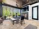 Stunning outdoor patio with wood ceiling, fireplace, TV and views of the lush greenery at 604 Dappled Pine Ave, Durham, NC 27713