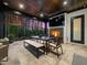 Inviting outdoor patio with stone fireplace, television, wood ceiling, and comfortable seating for entertaining at 604 Dappled Pine Ave, Durham, NC 27713