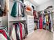 Spacious walk-in closet with built-in shelving, drawers, and hanging racks at 604 Dappled Pine Ave, Durham, NC 27713