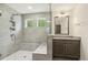 Modern bathroom with tiled shower, glass door and bench, vanity, and natural light at 605 Hampton Crest Ct, Fuquay Varina, NC 27526