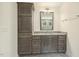 Bathroom vanity featuring granite countertops, a mirror, cabinet storage, and a towel rack at 605 Hampton Crest Ct, Fuquay Varina, NC 27526