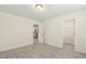 Bedroom features neutral carpet, white trim, and an open doorway to a closet at 605 Hampton Crest Ct, Fuquay Varina, NC 27526
