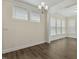 Dining room with wood floors and ample natural light, complemented by a modern chandelier at 605 Hampton Crest Ct, Fuquay Varina, NC 27526