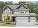 Charming two-story home with a three-car garage and stone accents, complemented by a well-maintained lawn at 605 Hampton Crest Ct, Fuquay Varina, NC 27526