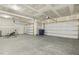 Spacious garage with concrete flooring and two overhead doors at 605 Hampton Crest Ct, Fuquay Varina, NC 27526