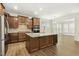 Spacious kitchen with wood cabinets, stainless steel appliances, and a large center island with a stone countertop at 605 Hampton Crest Ct, Fuquay Varina, NC 27526