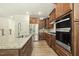 A well-equipped kitchen with wooden cabinets, granite countertops, stainless steel appliances and center island sink at 605 Hampton Crest Ct, Fuquay Varina, NC 27526