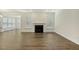Bright and open living room featuring a fireplace, hardwood floors, neutral paint, and natural light at 605 Hampton Crest Ct, Fuquay Varina, NC 27526