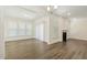 A bright living room featuring hardwood floors, natural light, and a fireplace at 605 Hampton Crest Ct, Fuquay Varina, NC 27526