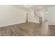 Spacious living room with hardwood floors, neutral paint, and a staircase leading to the upper level at 605 Hampton Crest Ct, Fuquay Varina, NC 27526