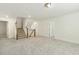 Neutral living room with carpeted floors and stairs to the second story at 605 Hampton Crest Ct, Fuquay Varina, NC 27526