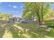 Spacious backyard featuring a wooden picnic table, lush greenery, and a serene outdoor space at 610 N Driver St, Durham, NC 27703