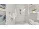 Bright bathroom showcasing tiled shower with niche, granite vanity, and contemporary design at 610 N Driver St, Durham, NC 27703
