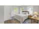 Well-lit bedroom with hardwood floors, neutral walls, and large windows for natural light at 610 N Driver St, Durham, NC 27703