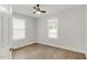 Simple bedroom with hardwood floors, neutral paint, ceiling fan, and natural light at 610 N Driver St, Durham, NC 27703