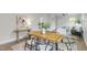 Open dining area with a wooden table, contemporary chairs, and seamless flow to the living space at 610 N Driver St, Durham, NC 27703