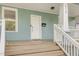 Close-up of the front porch with white railings and natural wood steps at 610 N Driver St, Durham, NC 27703