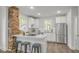 Modern kitchen with white cabinets, stainless steel appliances, and a breakfast bar at 610 N Driver St, Durham, NC 27703