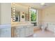 Bathroom with a double vanity, Hollywood lighting, and a window at 620 Martin Luther King Jr Blvd # Apt 502, Chapel Hill, NC 27514