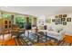 Bright living room featuring a white sofa, cozy chair, and balcony with scenic outdoor views at 620 Martin Luther King Jr Blvd # Apt 502, Chapel Hill, NC 27514