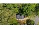 Overhead view of a house with a dark roof, surrounded by lush green trees offering privacy at 6904 Sandringham Dr, Raleigh, NC 27613
