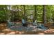 Beautiful backyard firepit area with Adirondack chairs, perfect for outdoor gatherings and relaxation at 6904 Sandringham Dr, Raleigh, NC 27613