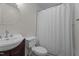 Charming bathroom featuring tile floors, a pedestal sink, and a shower with curtain at 6904 Sandringham Dr, Raleigh, NC 27613