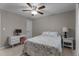 This comfortable bedroom features a ceiling fan, window, and desk at 6904 Sandringham Dr, Raleigh, NC 27613