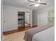Bright bedroom offers hardwood floors, a ceiling fan and a mirrored closet at 6904 Sandringham Dr, Raleigh, NC 27613
