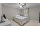This comfortable bedroom features a ceiling fan, window, and a neutral decor at 6904 Sandringham Dr, Raleigh, NC 27613