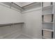 Walk-in closet features built-in shelving and hanging racks for optimal organization and storage solutions at 6904 Sandringham Dr, Raleigh, NC 27613