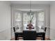 Bright dining area with bay window, granite-top table, and stylish lighting, creating the perfect space for Gathering meals at 6904 Sandringham Dr, Raleigh, NC 27613