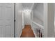 Bright hallway featuring hardwood floors, crisp white trim, and neutral paint at 6904 Sandringham Dr, Raleigh, NC 27613
